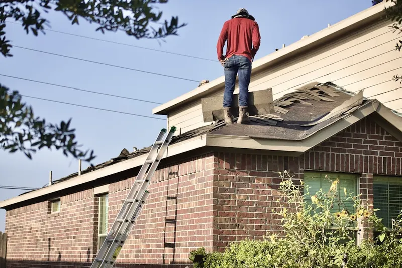 Professional roofer working on a residential roof in Flint Hill